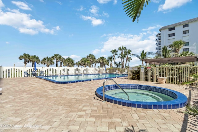 750 N Atlantic Ave Unit 203, Cocoa Beach, FL 32931 - community pool featuring a community hot tub and a patio area