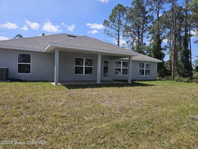 1101 Hanson Ave SW, Palm Bay, FL 32908 - rear view of property with roof with shingles, stucco siding, and a yard