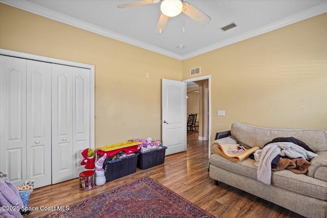 2097 Hidden Grove Ln Unit 106, Merritt Island, FL 32953 - living area with wood finished floors, ceiling fan, and ornamental molding