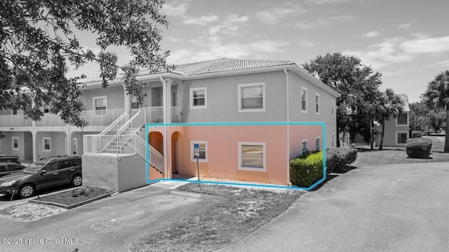 2097 Hidden Grove Ln Unit 106, Merritt Island, FL 32953 - view of front of house featuring stucco siding, a tiled roof, and stairs
