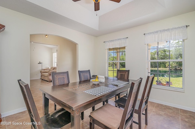 690 Grant Rd, Palm Bay, FL 32909 - dining room featuring arched walkways, ceiling fan, and light tile patterned floors
