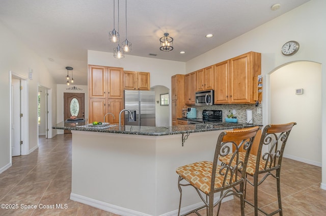 690 Grant Rd, Palm Bay, FL 32909 - kitchen featuring stainless steel appliances, arched walkways, light tile patterned flooring, tasteful backsplash, and recessed lighting