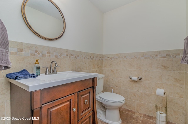 690 Grant Rd, Palm Bay, FL 32909 - half bathroom featuring tile walls, vanity, and a wainscoted wall