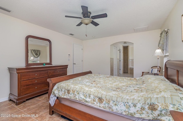 690 Grant Rd, Palm Bay, FL 32909 - tiled bedroom featuring arched walkways, ensuite bathroom, and a ceiling fan