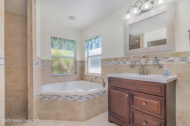 690 Grant Rd, Palm Bay, FL 32909 - bathroom with a garden tub, vanity, tile walls, and tile patterned floors