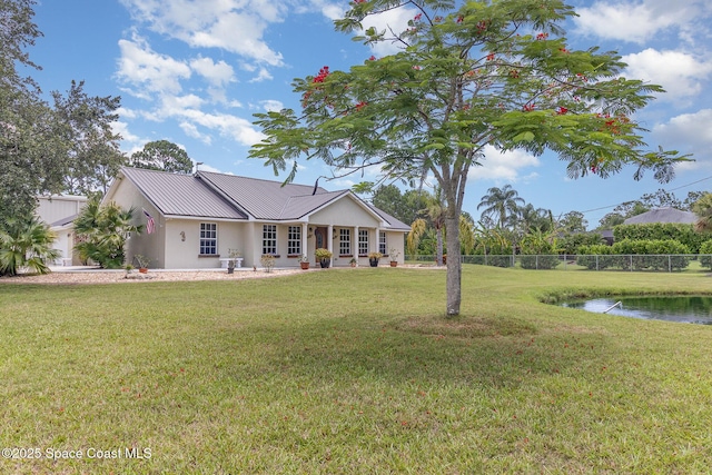 690 Grant Rd, Palm Bay, FL 32909 - single story home featuring a metal roof, stucco siding, a standing seam roof, and a water view