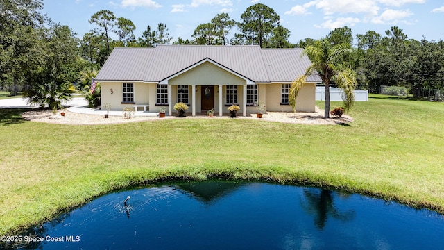 690 Grant Rd, Palm Bay, FL 32909 - back of property with stucco siding, a metal roof, and covered porch