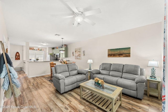 3498 Cutty Sark Way, Indialantic, FL 32903 - living room with ceiling fan and light wood-style flooring