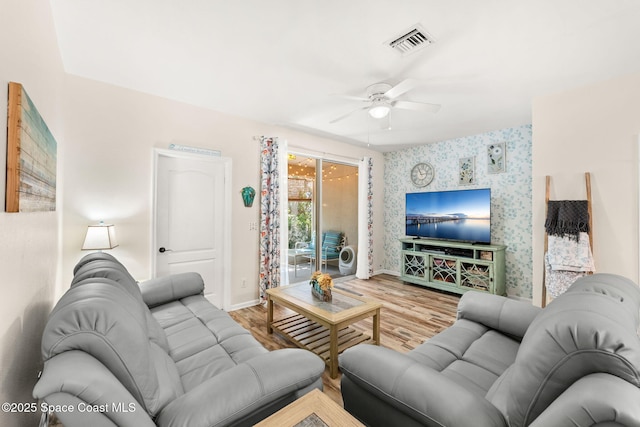 3498 Cutty Sark Way, Indialantic, FL 32903 - living area featuring wallpapered walls, ceiling fan, and wood finished floors