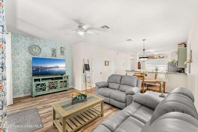 3498 Cutty Sark Way, Indialantic, FL 32903 - living area featuring ceiling fan, wood finished floors, and wallpapered walls