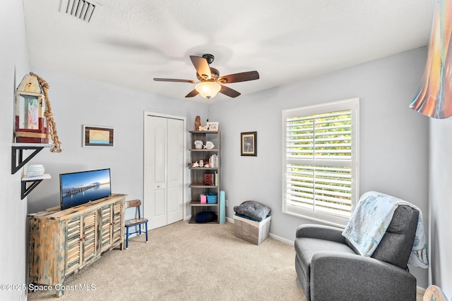 3498 Cutty Sark Way, Indialantic, FL 32903 - living area featuring a ceiling fan and carpet