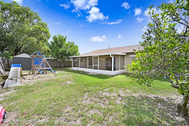 1327 Canterbury Ln, Rockledge, FL 32955 - fenced backyard featuring a sunroom, a playground, and a shed