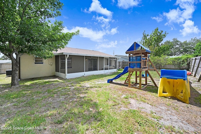 1327 Canterbury Ln, Rockledge, FL 32955 - fenced backyard with a playground and a sunroom
