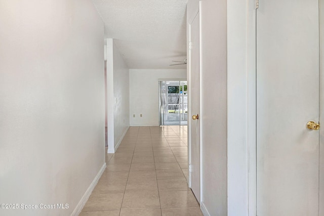 1327 Canterbury Ln, Rockledge, FL 32955 - corridor featuring light tile patterned flooring and a textured ceiling