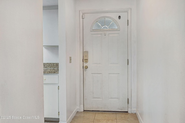 1327 Canterbury Ln, Rockledge, FL 32955 - doorway featuring light tile patterned floors and baseboards