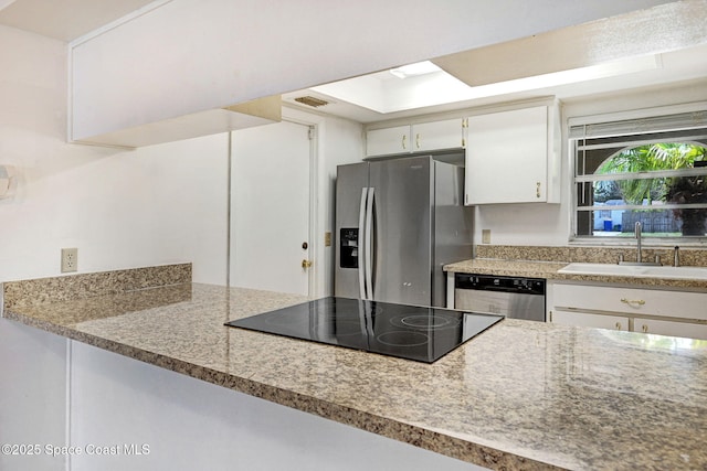 1327 Canterbury Ln, Rockledge, FL 32955 - kitchen featuring stainless steel appliances, white cabinets, and light stone counters