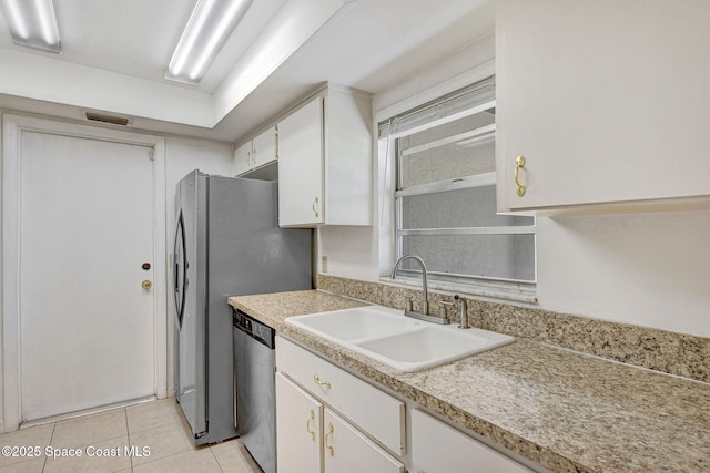 1327 Canterbury Ln, Rockledge, FL 32955 - kitchen with stainless steel dishwasher, white cabinets, light countertops, and light tile patterned flooring