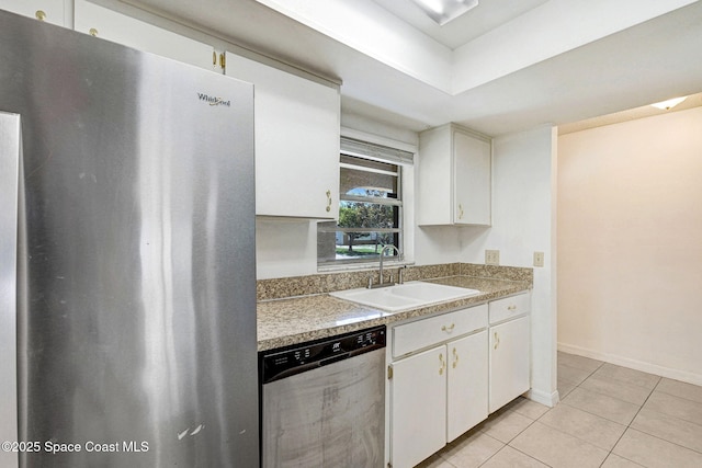 1327 Canterbury Ln, Rockledge, FL 32955 - kitchen with stainless steel appliances, light tile patterned floors, white cabinetry, and light countertops