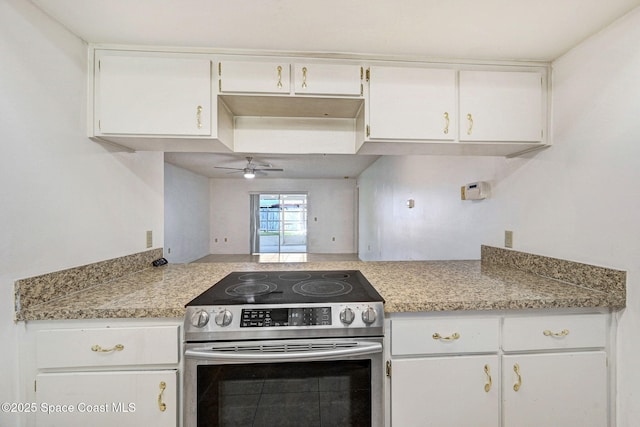1327 Canterbury Ln, Rockledge, FL 32955 - kitchen featuring electric stove, light countertops, white cabinetry, and a ceiling fan