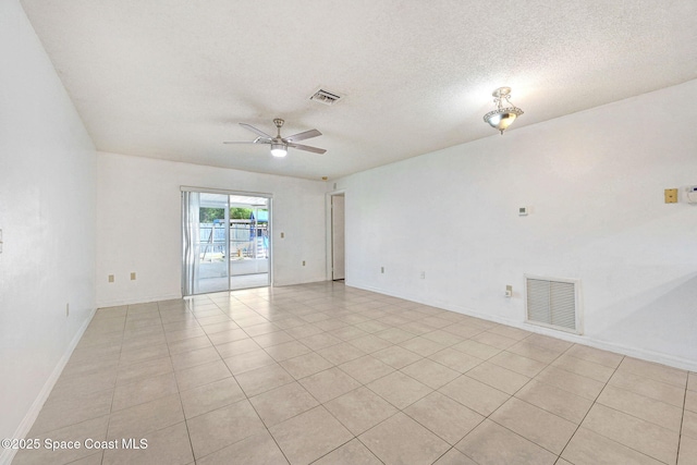 1327 Canterbury Ln, Rockledge, FL 32955 - empty room with ceiling fan, light tile patterned floors, and a textured ceiling