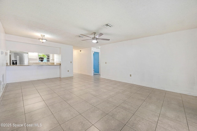 1327 Canterbury Ln, Rockledge, FL 32955 - unfurnished living room with ceiling fan, a textured ceiling, and light tile patterned floors