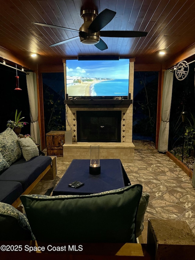 3601 Oneida St, Cocoa, FL 32926 - home theater room with ceiling fan, wooden ceiling, and a fireplace