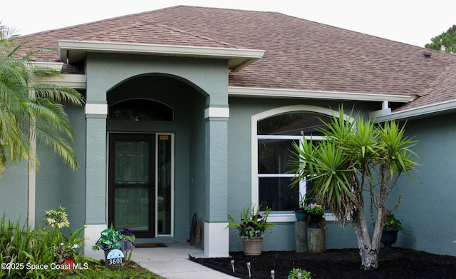 3601 Oneida St, Cocoa, FL 32926 - view of exterior entry featuring roof with shingles and stucco siding