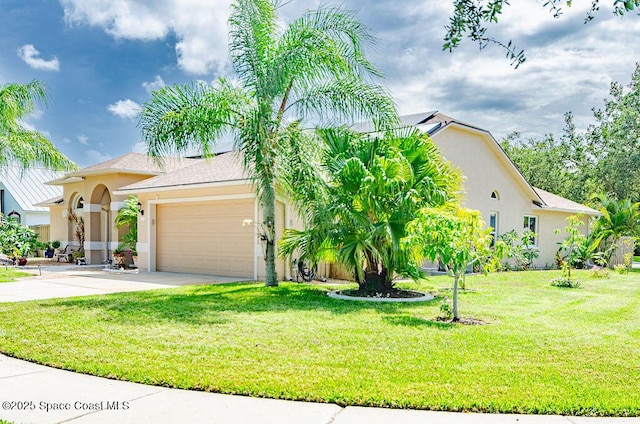 4204 Long Leaf Dr, Melbourne, FL 32940 - view of front of house with stucco siding, a garage, driveway, and a front yard