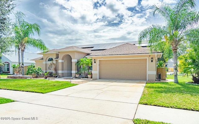 4204 Long Leaf Dr, Melbourne, FL 32940 - view of front of property with stucco siding, roof mounted solar panels, a front lawn, a garage, and concrete driveway