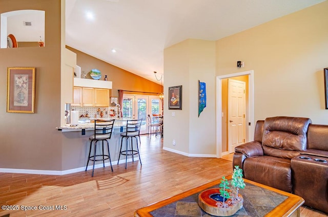 4204 Long Leaf Dr, Melbourne, FL 32940 - living area featuring light wood-style flooring, french doors, and high vaulted ceiling