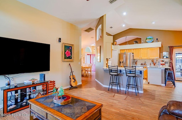 4204 Long Leaf Dr, Melbourne, FL 32940 - living room with light wood-style floors, lofted ceiling, and healthy amount of natural light