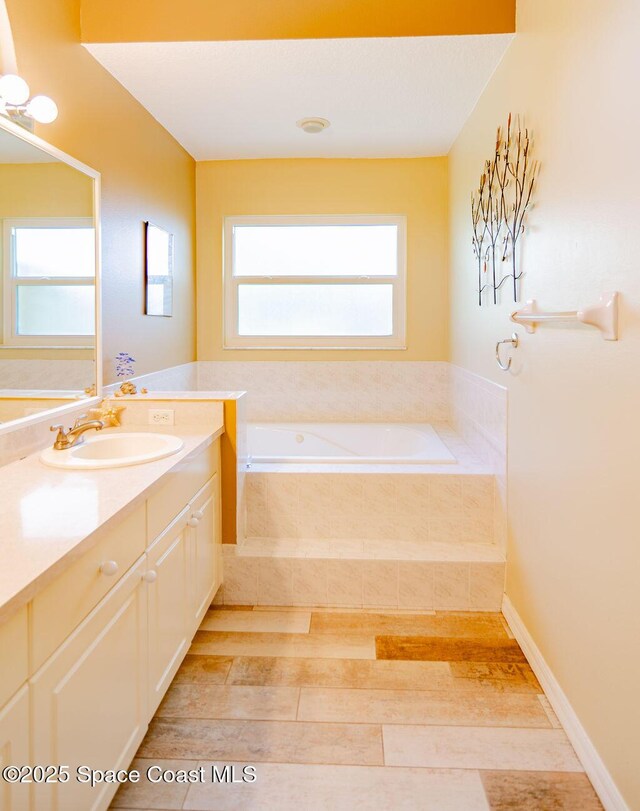 4204 Long Leaf Dr, Melbourne, FL 32940 - full bath featuring vanity, a garden tub, and wood finished floors
