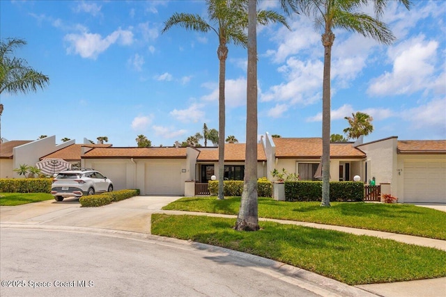 443 Hawthorne Ct, Indian Harbour Beach, FL 32937 - ranch-style home featuring an attached garage, driveway, a front lawn, and stucco siding