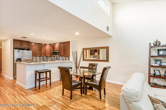 443 Hawthorne Ct, Indian Harbour Beach, FL 32937 - dining room with light wood finished floors and recessed lighting
