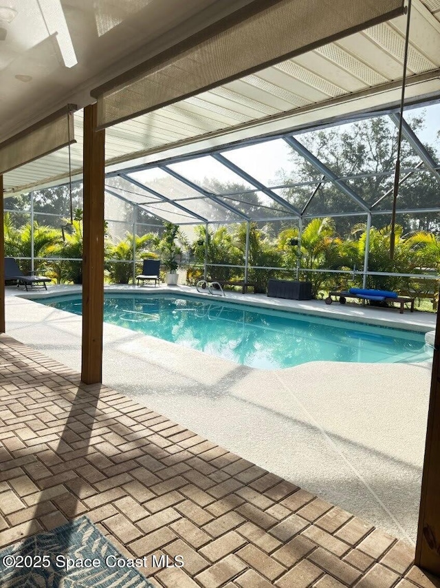 2940 Friday Ln, Cocoa, FL 32926 - outdoor pool featuring glass enclosure and a patio