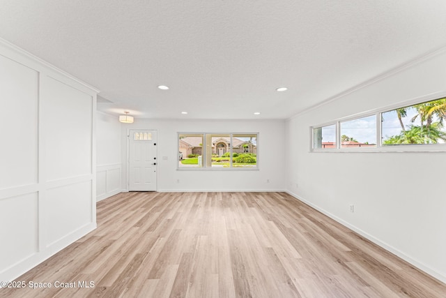 332 Nikomas Way, Melbourne Beach, FL 32951 - unfurnished living room featuring light wood finished floors and recessed lighting