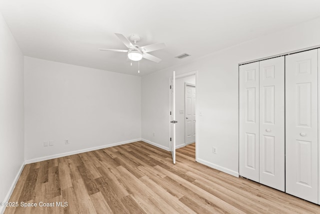332 Nikomas Way, Melbourne Beach, FL 32951 - unfurnished bedroom with light wood-style floors, a closet, and ceiling fan