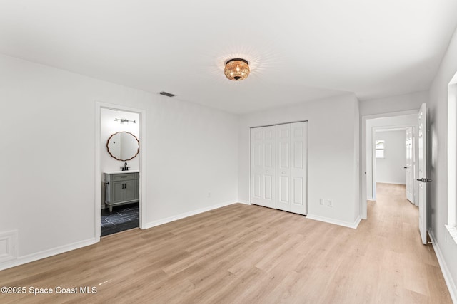 332 Nikomas Way, Melbourne Beach, FL 32951 - unfurnished bedroom featuring light wood finished floors, a closet, and ensuite bathroom