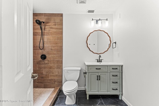 332 Nikomas Way, Melbourne Beach, FL 32951 - bathroom with vanity, a tile shower, and a textured ceiling