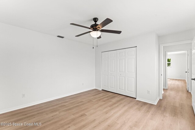 332 Nikomas Way, Melbourne Beach, FL 32951 - unfurnished bedroom featuring light wood-style floors, a closet, and ceiling fan