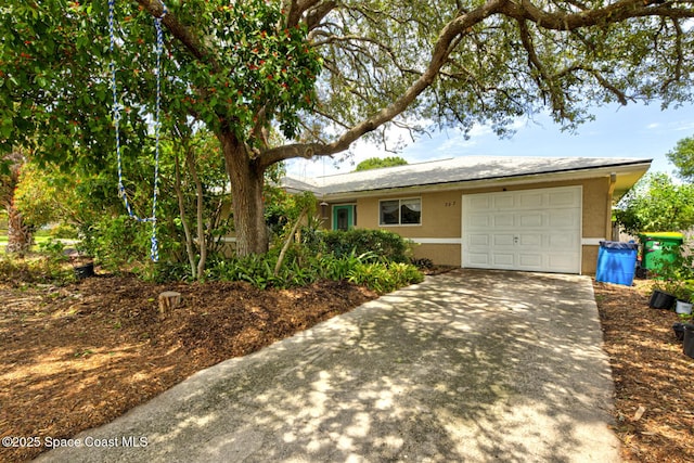 767 Adolph Ln, Cocoa, FL 32927 - ranch-style home featuring stucco siding, driveway, and a garage