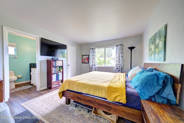 767 Adolph Ln, Cocoa, FL 32927 - bedroom featuring multiple windows, wood finished floors, and ensuite bath