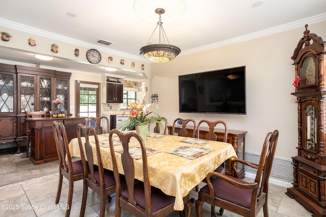 716 Endicott Rd, Melbourne, FL 32940 - dining space featuring ornamental molding and stone tile floors