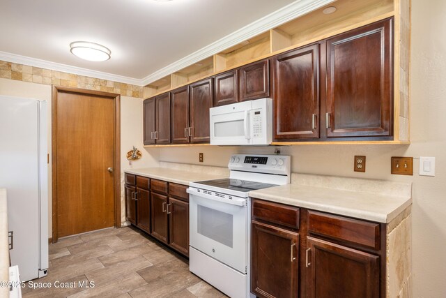716 Endicott Rd, Melbourne, FL 32940 - kitchen with white appliances, light countertops, dark brown cabinetry, and crown molding