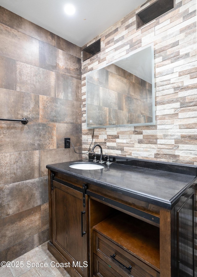 716 Endicott Rd, Melbourne, FL 32940 - bathroom featuring vanity, tile walls, and backsplash