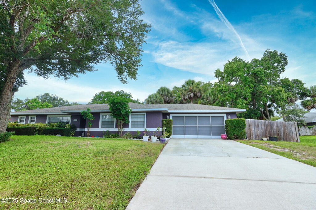 686 Joy St, Sebastian, FL 32958 - ranch-style home with concrete driveway and an attached garage