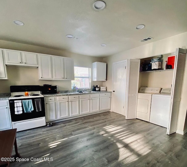 3717 Pinewood Dr NE Unit 12, Palm Bay, FL 32905 - kitchen featuring electric range, washer and dryer, white cabinets, dark wood-type flooring, and recessed lighting