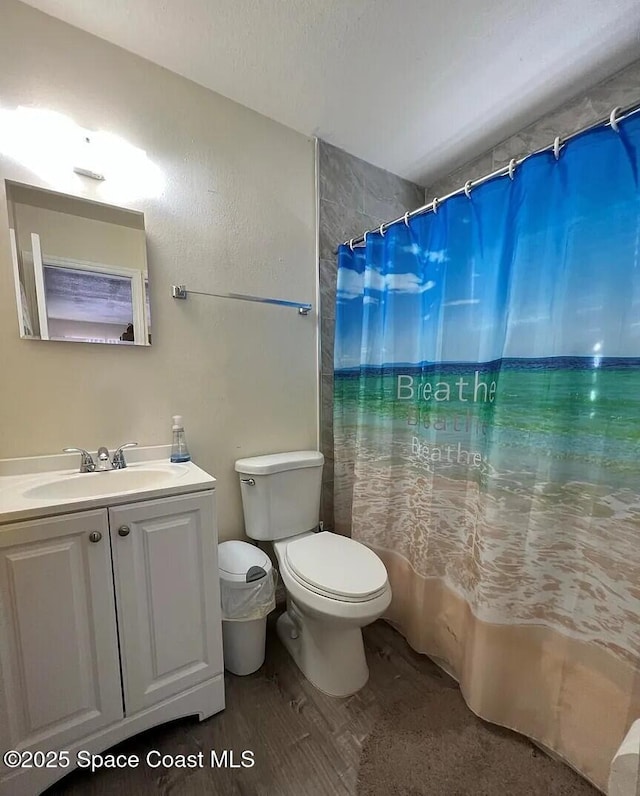 3717 Pinewood Dr NE Unit 12, Palm Bay, FL 32905 - full bathroom with vanity, a shower with shower curtain, and wood finished floors