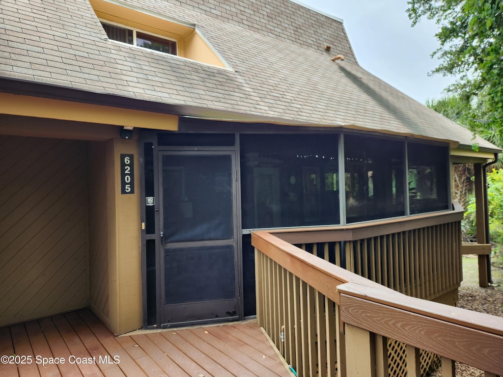 6205 Treetop Dr, Melbourne Beach, FL 32951 - wooden deck featuring a sunroom