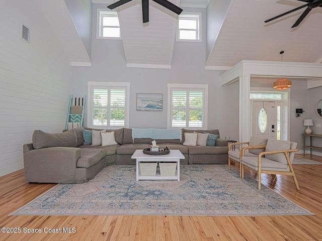 406 9th Ct, Vero Beach, FL 32962 - living room featuring ceiling fan, a high ceiling, healthy amount of natural light, and wood finished floors